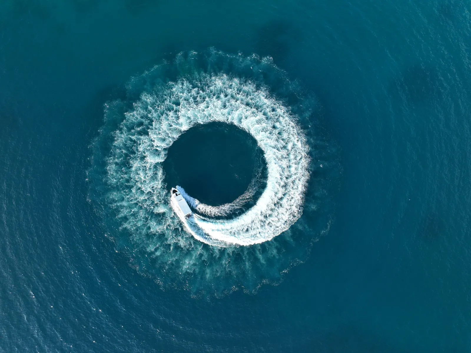 A speedboat crossing the turquoise waters of the Maldives
